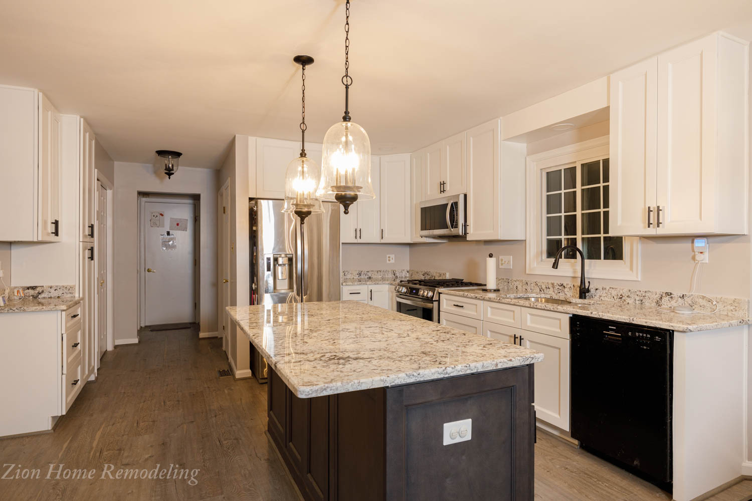 Modern kitchen with additional gray cabinets on one wall, showcasing coffee station and pantry, with white base cabinets and gray island in the background.